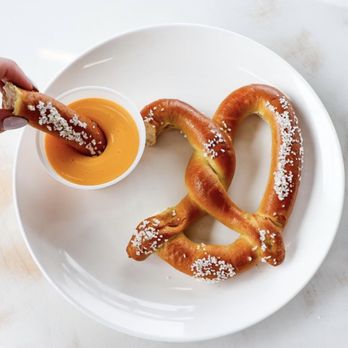FiiZ Drinks - a pretzel being dipped with salt - Juice Bars & Smoothies Near Me - Plain City, Utah FiiZ Drinks - a pretzel being dipped with salt - Juice Bars & Smoothies Near Me - Plain City, Utah