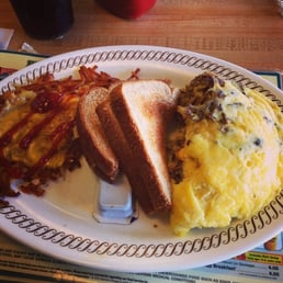 Steak egg and cheese omelet with covered hash browns.