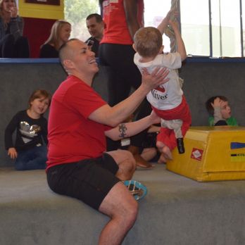 Cal Elite - Coach Alex guiding Oliver on the rope. - Gymnastics Near Me - Burbank, California Cal Elite - Coach Alex guiding Oliver on the rope. - Gymnastics Near Me - Burbank, California