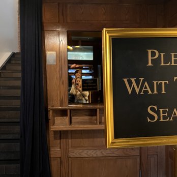Cloakroom Bar - a sign that reads please wait for the season - Cocktail Bars Near Me - Montreal, Quebec