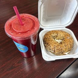 Bagel with cream cheese and pink passion juice. Bagel with cream cheese and pink passion juice.