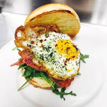 Plank Bar & Kitchen - Try our version of a breakfast sandwich. Our crispy fried egg sandwich features pesto aioli with arugula, crispy prosciutto and a fried egg! - Bars Near Me - Naperville, Illinois