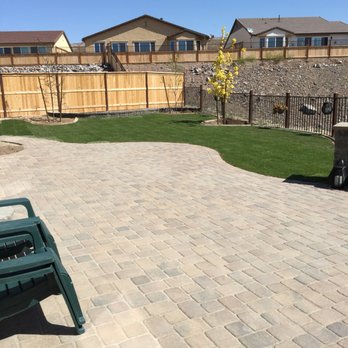 Environmental Concepts - a brick patio with a green bench - Landscaping Near Me Environmental Concepts - a brick patio with a green bench - Landscaping Near Me