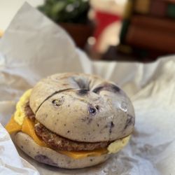 Breakfast blueberry bagel sandwich with sausage scramble and cheddar $7.95