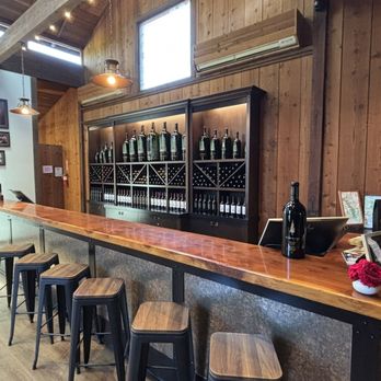 Sequoia Grove Winery - Bar seating: Bar stools with the wine wall behind - Wine Tasting Room Near Me - Rutherford, California