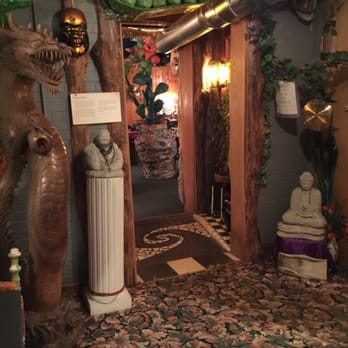Purple Chopstix - a hallway with a statue of a dragon and a statue of a man - New American Near Me - Athens, Ohio