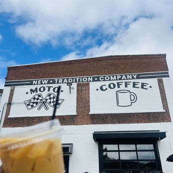 New Tradition Co - a person holding a drink outside of a coffee shop - Coffee & Tea Near Me - Worcester, Massachusetts