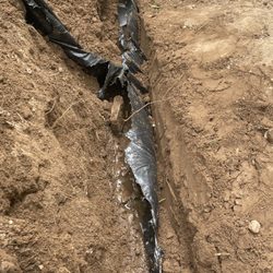 Dolce Vita Landscaping - Low spot leaking at corrugated T connection, bad pitch.