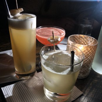 Attaboy - Clockwise, from left: Invisible Gin, Siesta, (candle), Son of a Beesting - Cocktail Bars Near Me - Nashville, Tennessee Attaboy - Clockwise, from left: Invisible Gin, Siesta, (candle), Son of a Beesting - Cocktail Bars Near Me - Nashville, Tennessee