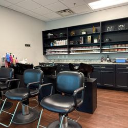 Riversong Spa & Salon - Riversong's new color bar and shampoo area featuring wash bowls, salon chairs, and a full wall of professional Redken color products.