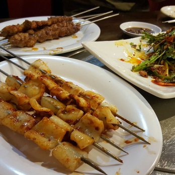 Kochi Maru - squid skewer, vegetable salad and beef skewer in the back - Chinese Near Me - Doraville, Georgia Kochi Maru - squid skewer, vegetable salad and beef skewer in the back - Chinese Near Me - Doraville, Georgia