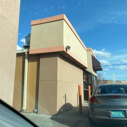 a car parked in front of a building a car parked in front of a building