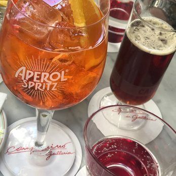 Camparino in Galleria - Aperol spritz, a classic drink that we forgot the name already plus fizzy water - Cafes Near Me - Milan, Michigan