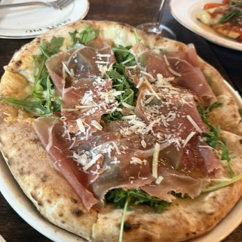Olio e Più - We got the server's recommendation, a prosciutto pizza with a bed of arugula. - Pizza Near Me - New York, New York Olio e Più - We got the server's recommendation, a prosciutto pizza with a bed of arugula. - Pizza Near Me - New York, New York