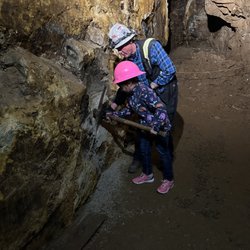 Capital Prize Gold Mine Tours - Paul with our daughter explaining how they mined veins.