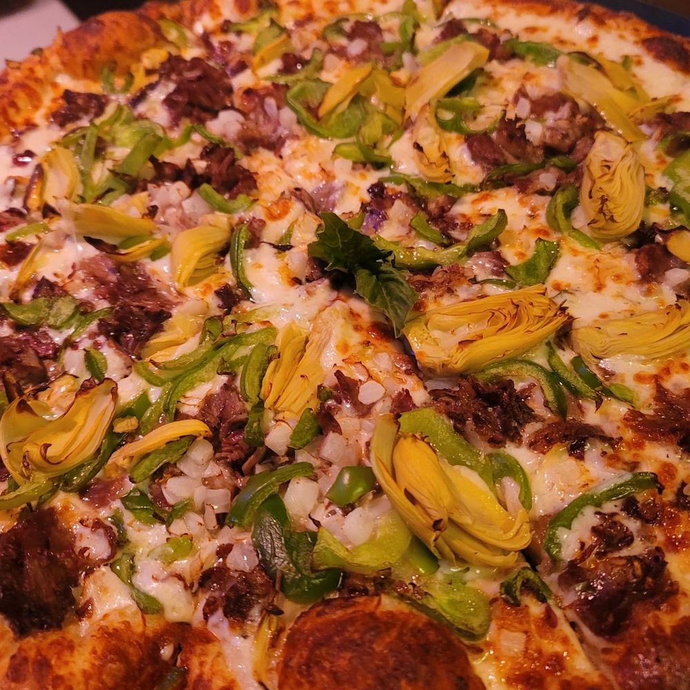 Vinny McGuire's - Prime rib Philly cheese steak pizza with artichokes. - Pizza Near Me - Destin, Florida Vinny McGuire's - Prime rib Philly cheese steak pizza with artichokes. - Pizza Near Me - Destin, Florida