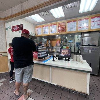 Wendy's - Waited behind this guy inside for over 10 min!! Look at all the trash in the counter, the dirty floors!!! - Fast Food Near Me - Corona, California