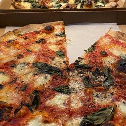 a pizza in a box with a slice taken out of it