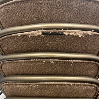 The Seating Shoppe - A stack of six chairs with fabric seats and backs, showing signs of wear and tear, with metal frames. - Wholesale Stores Near Me - Harrison, New Jersey