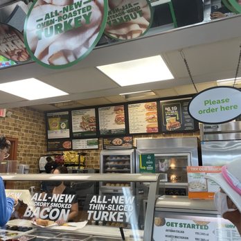 Subway - a woman standing in front of a counter - Sandwiches Near Me - Miami, Florida