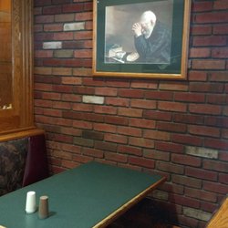 McDonald's - Framed art, a brick wall, display case, and upholstered booths. Say what?