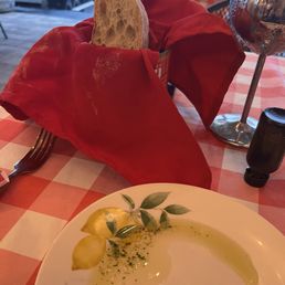 The oil with herbs on the plate and warm soft bread in the can.