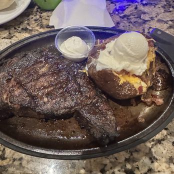 Black Angus Steakhouse - 16 oz Ribeye with loaded Baked Potato - Steakhouses Near Me - Kissimmee, Florida Black Angus Steakhouse - 16 oz Ribeye with loaded Baked Potato - Steakhouses Near Me - Kissimmee, Florida