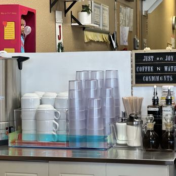 Just En Joy - Condiments table. Coffee on the left and water container on the right side - Filipino Near Me - Vallejo, California Just En Joy - Condiments table. Coffee on the left and water container on the right side - Filipino Near Me - Vallejo, California