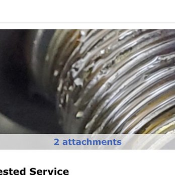 Jiffy Lube - This is how they left the threads for my oil filter - A detailed close-up of a metallic, coiled object with shiny, reflective layers, possibly part of a mechanical or industrial component. - Oil Change Stations Near Me - Plainfield, Illinois
