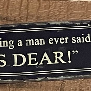 Perkos Restaurant - a sign on a door saying,'smartest thing a man ever said yes dear ' - A rectangular sign with a black background and white decorative border displays a humorous quote about a man's response to a proposal. - Diners Near Me - Modesto, California