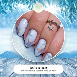 Organic Nail Lounge - Shine bright in 2026 with iridescent holographic stars on a fresh white base. A magical look for the new year. Visit Organic Nail Loung