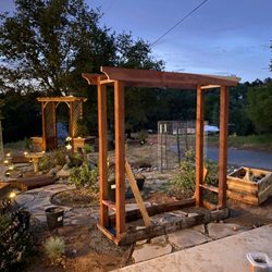 Utley & Sons Land & Woodworks - Evening light catching the curve of a garden coming to life -- arbor builds, flagstone paths, and a whole lot of intention.