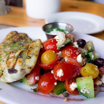 Kentro Greek Kitchen - Psari Sti Skara (Char-broiled Sea Bass) with lemon, and side of Horiatiki (Tomatoes, Cucumber, Feta, Kalamata, Olives, & Onions - Greek Near Me - Fullerton, California Kentro Greek Kitchen - Psari Sti Skara (Char-broiled Sea Bass) with lemon, and side of Horiatiki (Tomatoes, Cucumber, Feta, Kalamata, Olives, & Onions - Greek Near Me - Fullerton, California