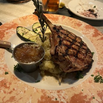 Copper Grill - Pork chop with apple compote, mashed potatoes and grilled zucchini. - New American Near Me - Little Rock, Arkansas Copper Grill - Pork chop with apple compote, mashed potatoes and grilled zucchini. - New American Near Me - Little Rock, Arkansas