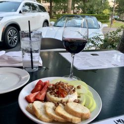 POUR Restaurant & Bar - Baked brie wrapped in puff pastry, topped with pepperjelly, pecans and sliced apples.
