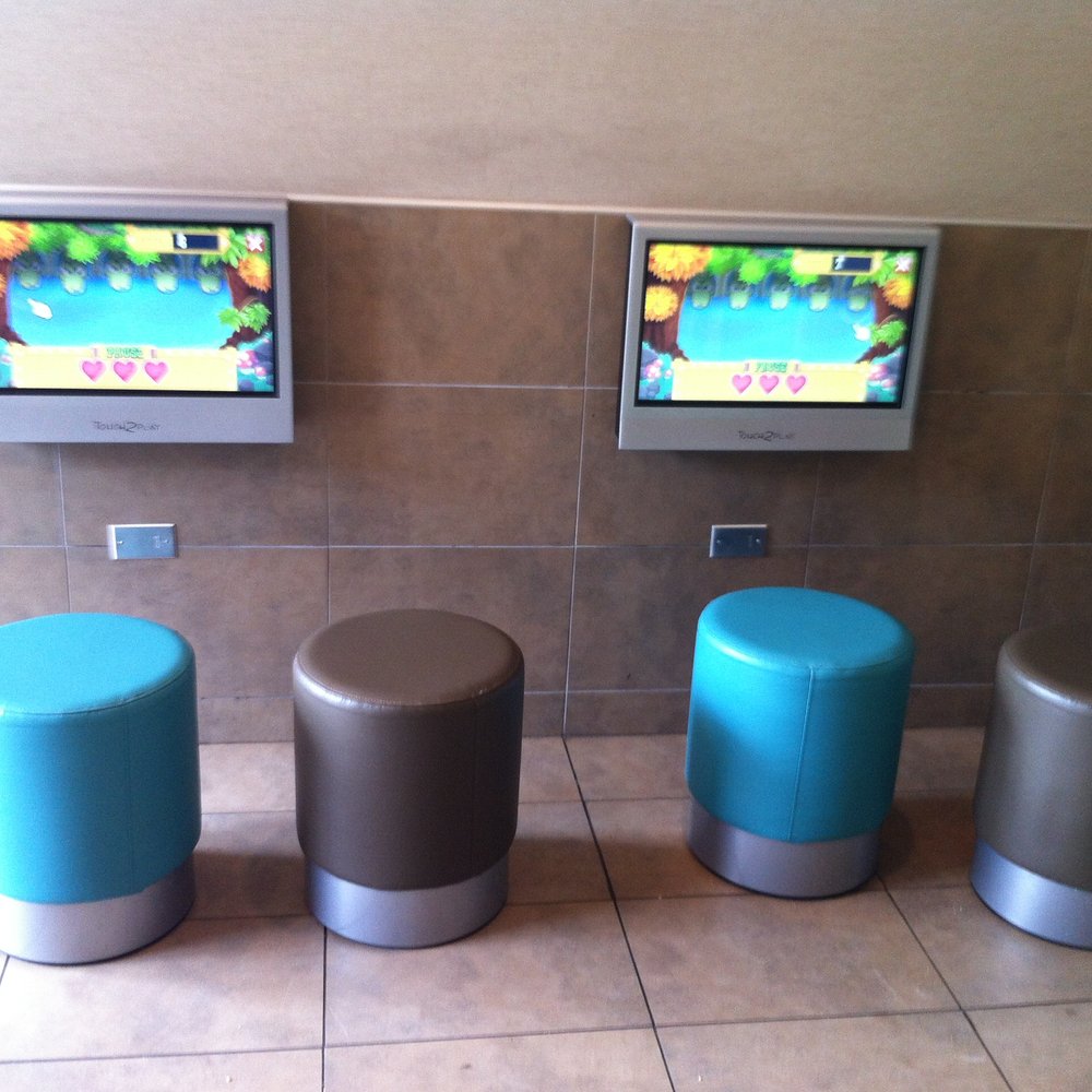 McDonald's - a row of stools and televisions - Burgers Near Me - Imlay City, Michigan