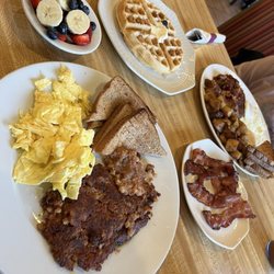 Hash and eggs, side of bacon, Belgium waffle, fresh fruit on side