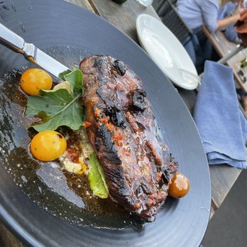 The Backyard - Ribeye steak with potato-leek Mahon gratin, tomato confit and black olive piri piri $65 - Belgian Near Me - Los Angeles, California
