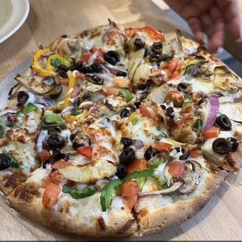 Edible Happy Pizzeria - This was the picture I viewed on Yelp of someone showing their pizza an stating that it's personal size. - Pizza Near Me - Oakland, California Edible Happy Pizzeria - This was the picture I viewed on Yelp of someone showing their pizza an stating that it's personal size. - Pizza Near Me - Oakland, California