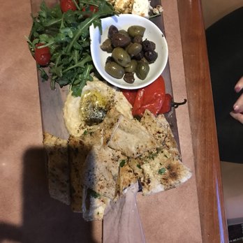 Bacchus Restaurant & Wine Bar - a plate of food on a table - Wine Bars Near Me - Rohnert Park, California
