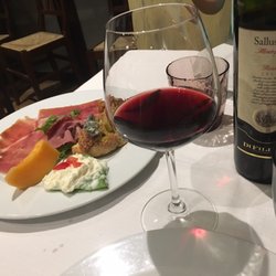 Il Cavaliere - Yummy wine with antipasto in the background- you can see the cheese has been on that plate for quite some time :0/