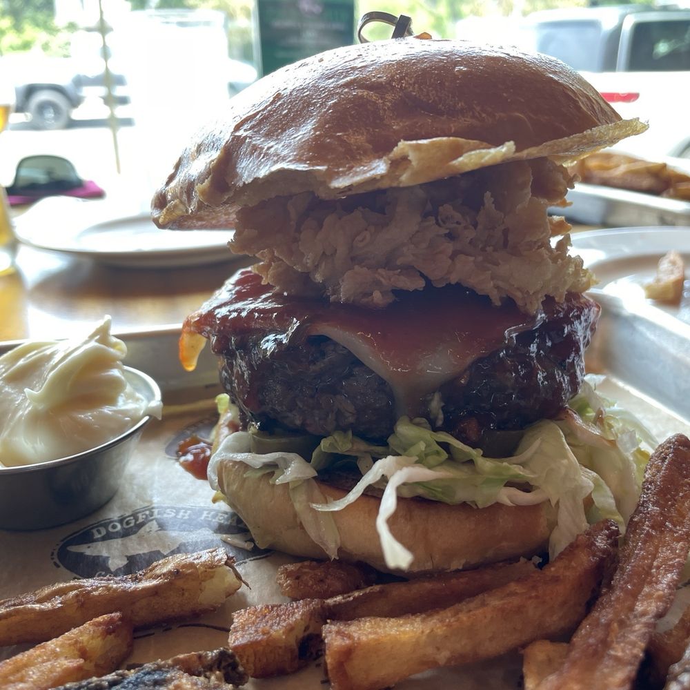 Dogfish Head Brewings & Eats - Cowboy burger with crispy onion rings. Really good. - American Near Me - Rehoboth Beach, Delaware Dogfish Head Brewings & Eats - Cowboy burger with crispy onion rings. Really good. - American Near Me - Rehoboth Beach, Delaware