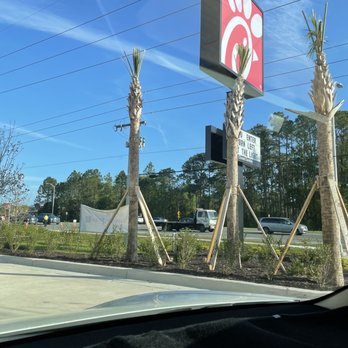 Chick-fil-A - ows palm trees in front of a chick - fil - a - fil sign - Fast Food Near Me - Saint Augustine, Florida