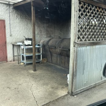 Dixieland BBQ - Smoker out back.  Real wood laying around. No gas or electricity in sight. - Barbeque Near Me - Batesville, Mississippi