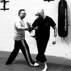 Guangzhou Wing Chun Academy - Showing student how to escape leg lock