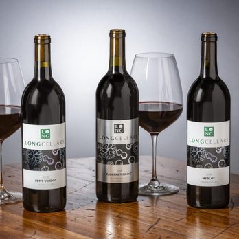 Long Cellars - three bottles of wine and a glass of wine - Wineries Near Me - Woodinville, Washington