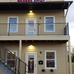 Jack's exterior view from side street. HWY 290 is to the right, one block away. To the right is Manor Lube.