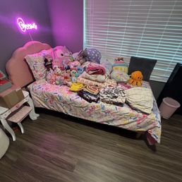 Daughter rooms - clean floors, clothes folded, placed on the bed, bed made.
