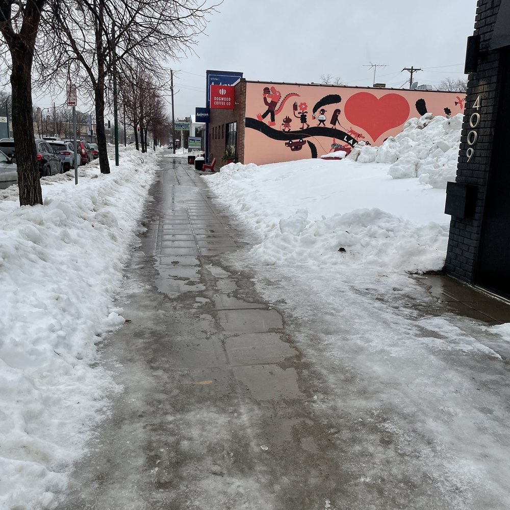 a snowy sidewalk with a heart painted on it a snowy sidewalk with a heart painted on it
