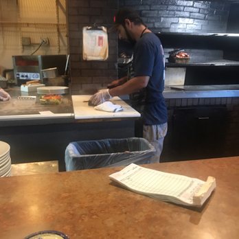 Bono's Pit Bar-B-Q - This hard working guy is busting it to chop all kinds of yummy bbq meats!  Sit at the bar for fast service. - Barbeque Near Me - Jacksonville, Florida